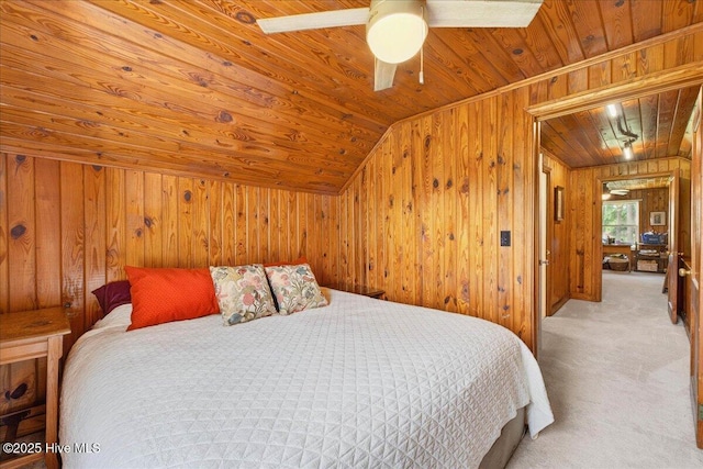 carpeted bedroom with wooden ceiling, wood walls, vaulted ceiling, and ceiling fan