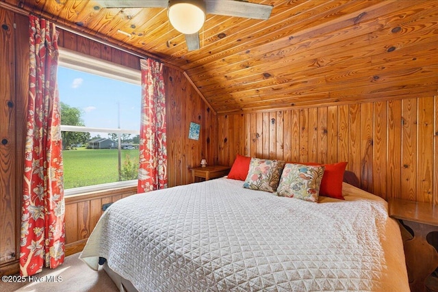 bedroom with wood ceiling, wood walls, multiple windows, lofted ceiling, and a ceiling fan