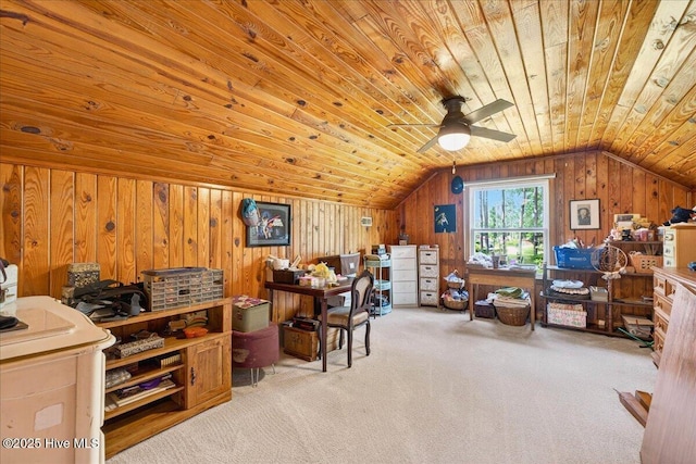 carpeted office space featuring vaulted ceiling, wood ceiling, wooden walls, and ceiling fan