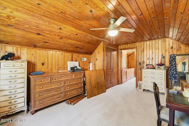 carpeted bedroom with lofted ceiling, wood ceiling, and wood walls