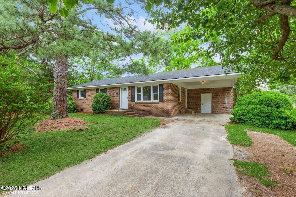 111 Waverly Faison Rd, Faison, NC 28341 - ranch-style home featuring concrete driveway, brick siding, a front yard, and an attached carport