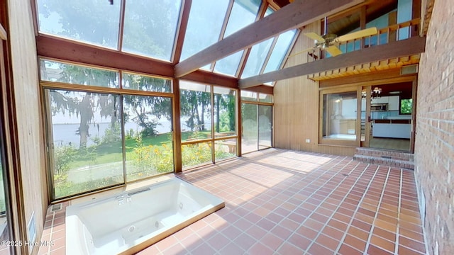 1402 Green Springs Rd, New Bern, NC 28560 - unfurnished sunroom featuring a towering ceiling, tile patterned flooring, a water view, and a skylight