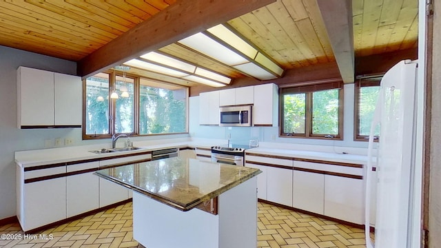 1402 Green Springs Rd, New Bern, NC 28560 - kitchen with appliances with stainless steel finishes, brick patterned flooring, a wood ceiling with exposed beams, white cabinets, and plenty of natural light