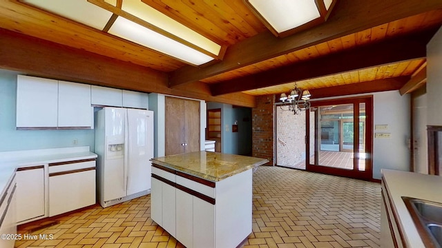 1402 Green Springs Rd, New Bern, NC 28560 - kitchen with white fridge with ice dispenser, brick flooring, a wooden ceiling with exposed beams, white cabinets, and a chandelier