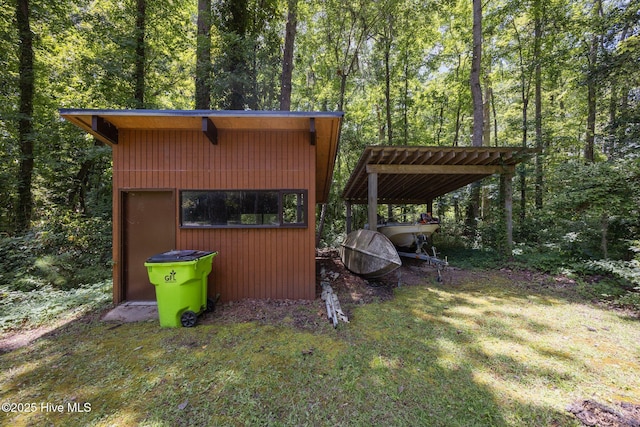 1402 Green Springs Rd, New Bern, NC 28560 - view of outbuilding with a forest view and a detached carport