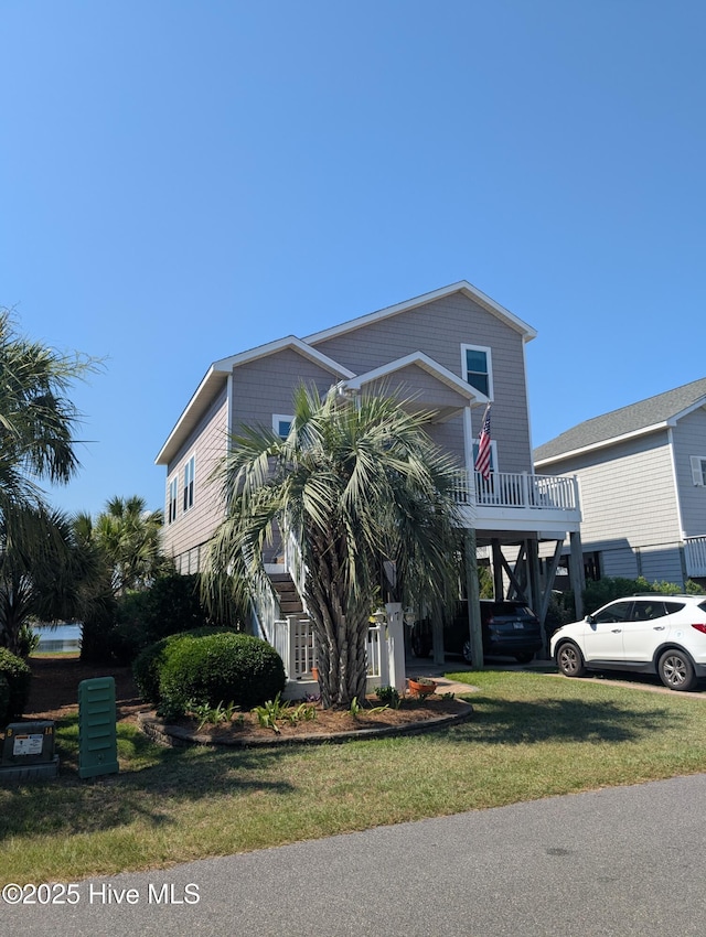 7 Oleander Ln, Ocean Isle Beach, NC 28469 - raised beach house with a front lawn