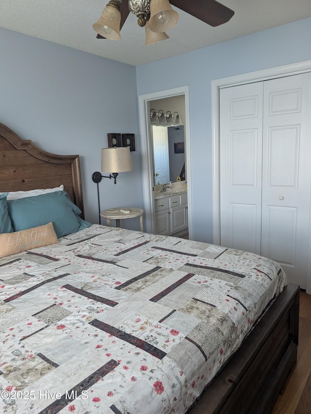 7 Oleander Ln, Ocean Isle Beach, NC 28469 - bedroom featuring a closet, wood finished floors, ensuite bathroom, and ceiling fan