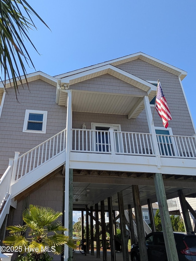 7 Oleander Ln, Ocean Isle Beach, NC 28469 - view of home's exterior featuring a carport and stairs