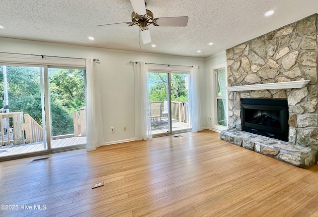 122 Ethel Dr, Emerald Isle, NC 28594 - unfurnished living room featuring a textured ceiling, a ceiling fan, wood finished floors, a fireplace, and recessed lighting