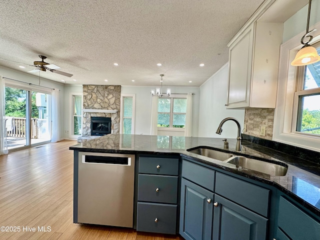 122 Ethel Dr, Emerald Isle, NC 28594 - kitchen featuring dishwasher, a peninsula, a textured ceiling, open floor plan, and light wood finished floors