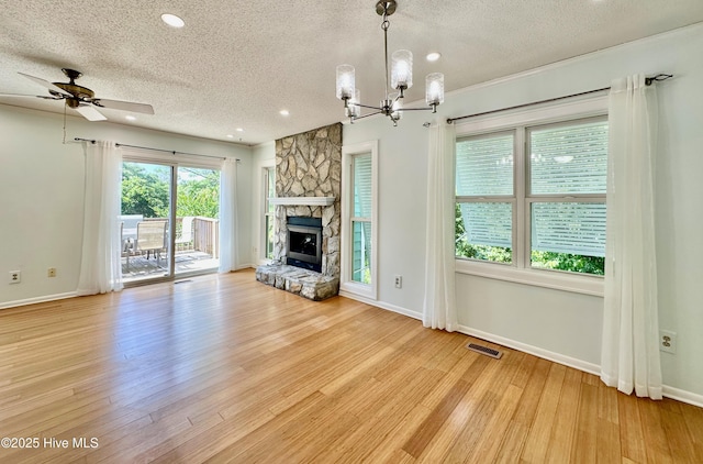 122 Ethel Dr, Emerald Isle, NC 28594 - unfurnished living room with a textured ceiling, a chandelier, a fireplace, recessed lighting, and ceiling fan