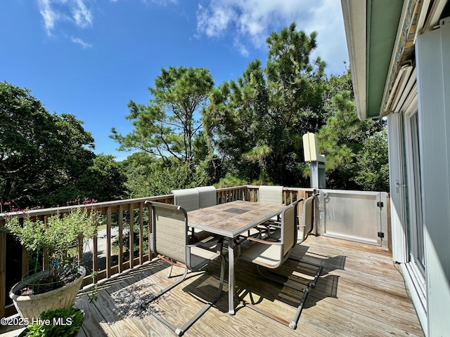 122 Ethel Dr, Emerald Isle, NC 28594 - deck with outdoor dining space and view of scattered trees
