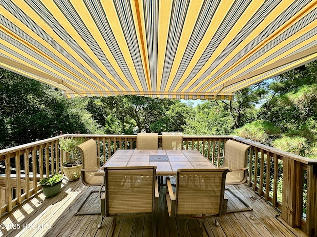 122 Ethel Dr, Emerald Isle, NC 28594 - wooden terrace with outdoor dining space and view of scattered trees