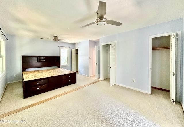 122 Ethel Dr, Emerald Isle, NC 28594 - unfurnished bedroom featuring two closets, a ceiling fan, and light carpet