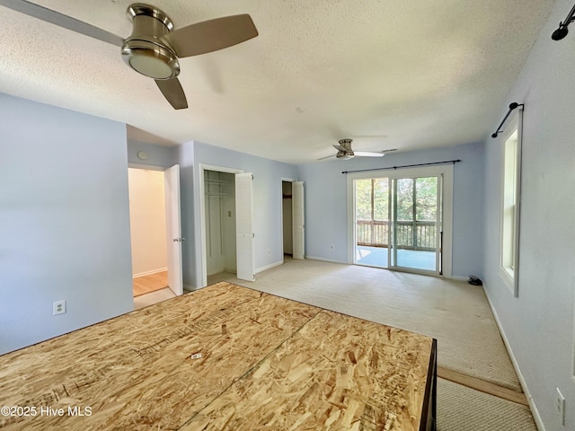 122 Ethel Dr, Emerald Isle, NC 28594 - unfurnished bedroom with access to exterior, a textured ceiling, light carpet, and a ceiling fan