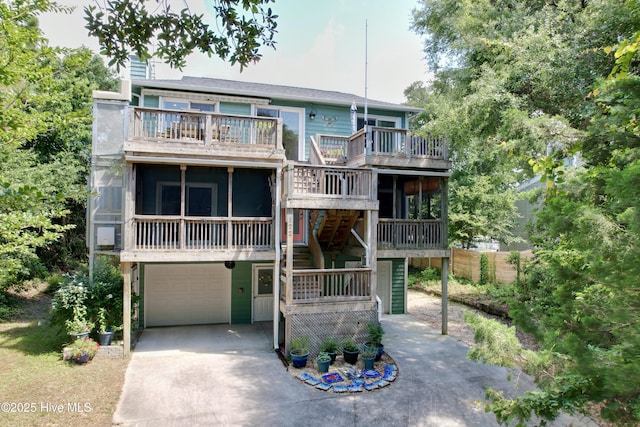 122 Ethel Dr, Emerald Isle, NC 28594 - view of front of property with a garage, concrete driveway, stairway, and a balcony