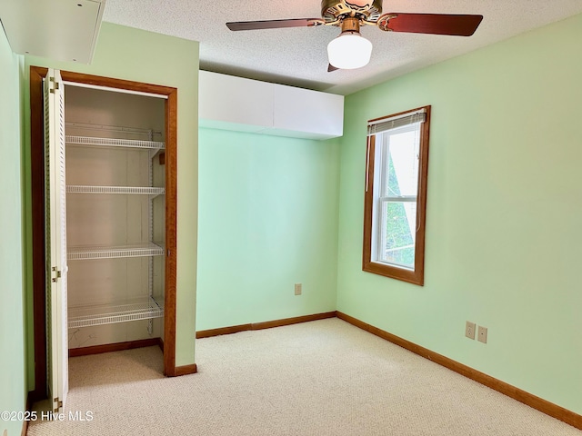 122 Ethel Dr, Emerald Isle, NC 28594 - unfurnished bedroom featuring carpet, a closet, a textured ceiling, and ceiling fan