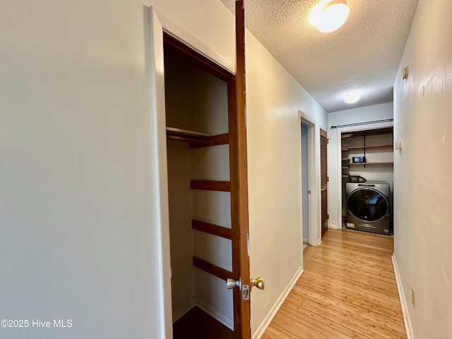 122 Ethel Dr, Emerald Isle, NC 28594 - hall featuring washer / dryer, a textured ceiling, and light wood finished floors