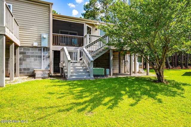 7161 Windward Dr, New Bern, NC 28560 - rear view of property featuring stairs, a lawn, a sunroom, and a deck
