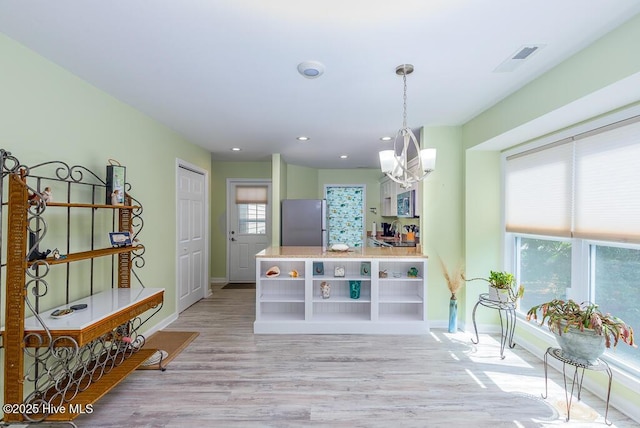 7161 Windward Dr, New Bern, NC 28560 - kitchen with appliances with stainless steel finishes, a chandelier, open shelves, light wood-style flooring, and decorative light fixtures