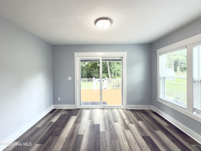 9891 Red Fox, Winnabow, NC 28479 - empty room featuring healthy amount of natural light and dark wood finished floors