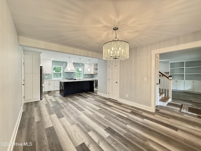 9891 Red Fox, Winnabow, NC 28479 - kitchen featuring light countertops, white cabinetry, a chandelier, wood finished floors, and freestanding refrigerator