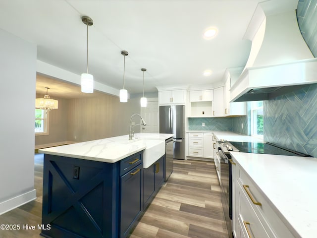 9891 Red Fox, Winnabow, NC 28479 - kitchen with custom exhaust hood, appliances with stainless steel finishes, blue cabinetry, white cabinets, and recessed lighting