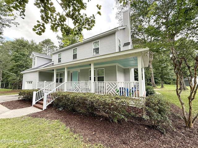 9891 Red Fox, Winnabow, NC 28479 - farmhouse inspired home with a porch and a chimney