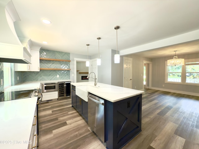 9891 Red Fox, Winnabow, NC 28479 - kitchen with custom range hood, stainless steel appliances, beverage cooler, a chandelier, and decorative backsplash