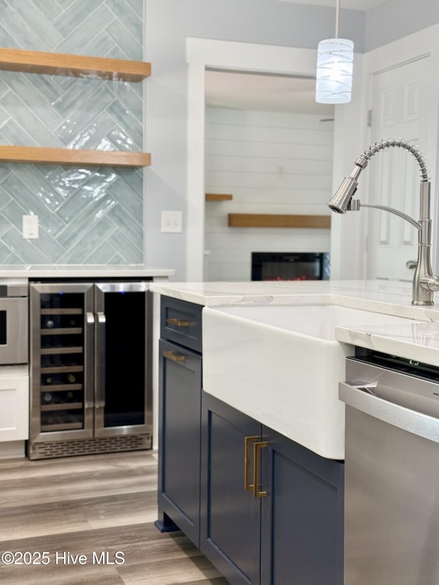 9891 Red Fox, Winnabow, NC 28479 - kitchen featuring stainless steel dishwasher, beverage cooler, light wood finished floors, and light countertops