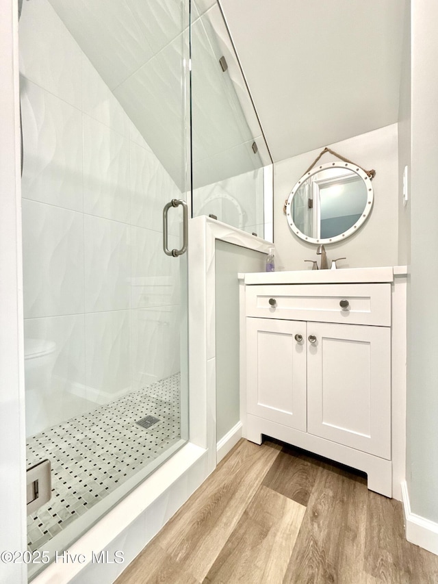 9891 Red Fox, Winnabow, NC 28479 - bathroom with wood finished floors, lofted ceiling, a stall shower, and vanity