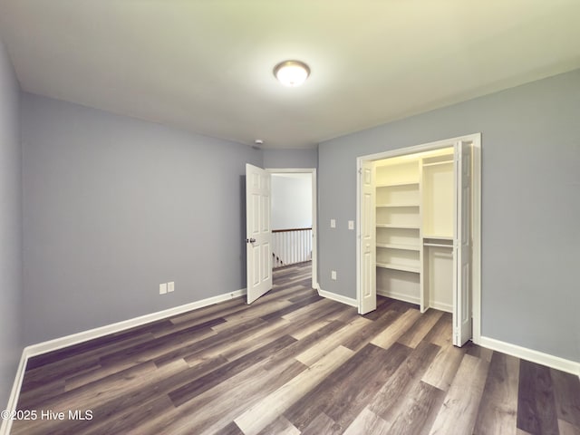 9891 Red Fox, Winnabow, NC 28479 - unfurnished bedroom featuring dark wood-style floors and a closet