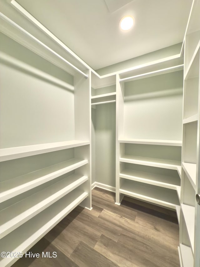 9891 Red Fox, Winnabow, NC 28479 - walk in closet with dark wood-type flooring