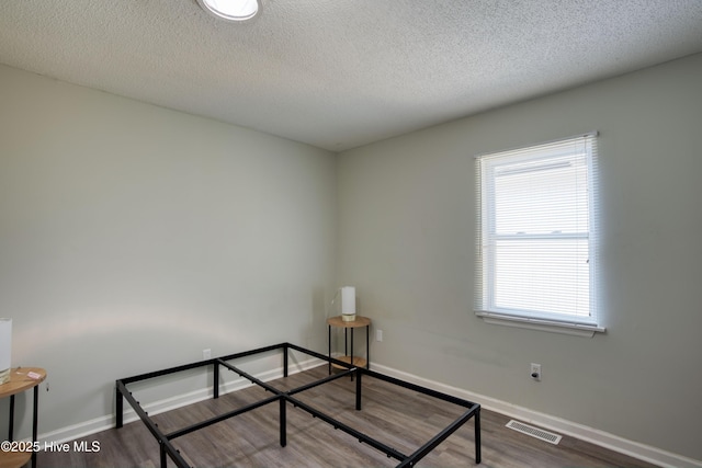 606 Anderson St, Wilmington, NC 28401 - unfurnished bedroom featuring wood finished floors and a textured ceiling
