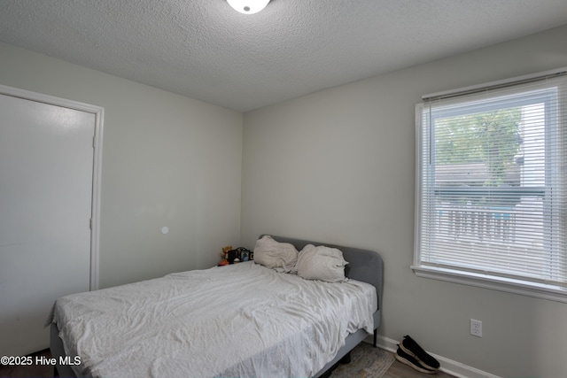 606 Anderson St, Wilmington, NC 28401 - bedroom with a textured ceiling and baseboards