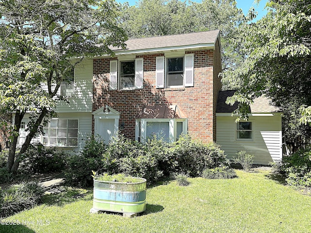 735 N Bennett St Unit A, Southern Pines, NC 28387 - view of front of property with a front lawn, a shingled roof, and brick siding
