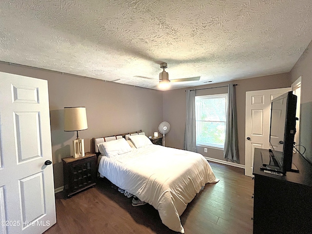 735 N Bennett St Unit A, Southern Pines, NC 28387 - bedroom featuring a textured ceiling, dark wood-style floors, and ceiling fan