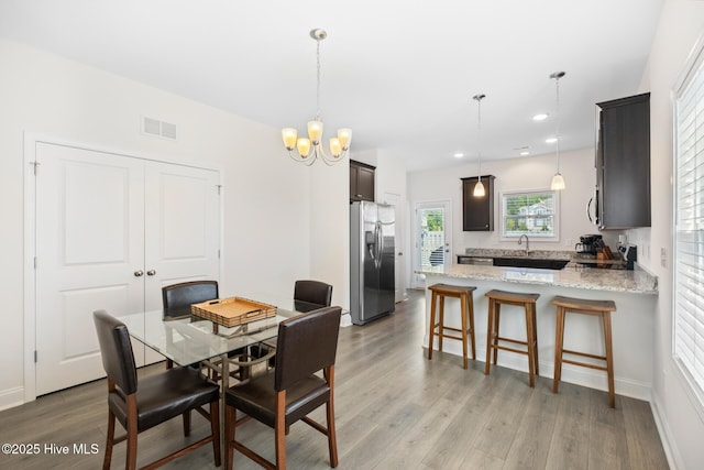 1620 Bratton Ct, Wilmington, NC 28405 - dining area featuring light wood finished floors, a chandelier, and recessed lighting