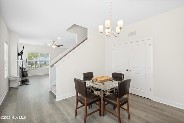1620 Bratton Ct, Wilmington, NC 28405 - dining space with stairs, wood finished floors, a chandelier, a ceiling fan, and recessed lighting
