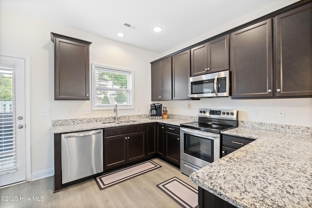 1620 Bratton Ct, Wilmington, NC 28405 - kitchen featuring stainless steel appliances, light wood finished floors, dark brown cabinetry, and recessed lighting