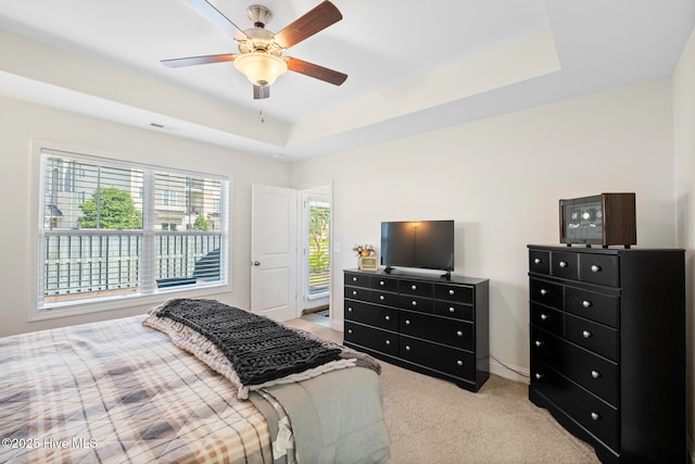 1620 Bratton Ct, Wilmington, NC 28405 - bedroom featuring light colored carpet, a tray ceiling, and ceiling fan