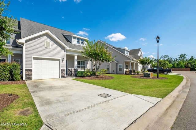 1620 Bratton Ct, Wilmington, NC 28405 - craftsman-style home with driveway, a front yard, a garage, roof with shingles, and stone siding