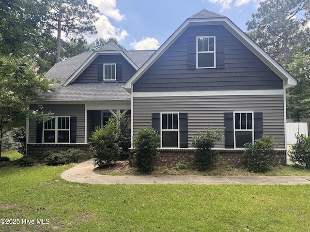 600 Burning Tree Rd, Pinehurst, NC 28374 - view of front of property featuring a front lawn, brick siding, and roof with shingles
