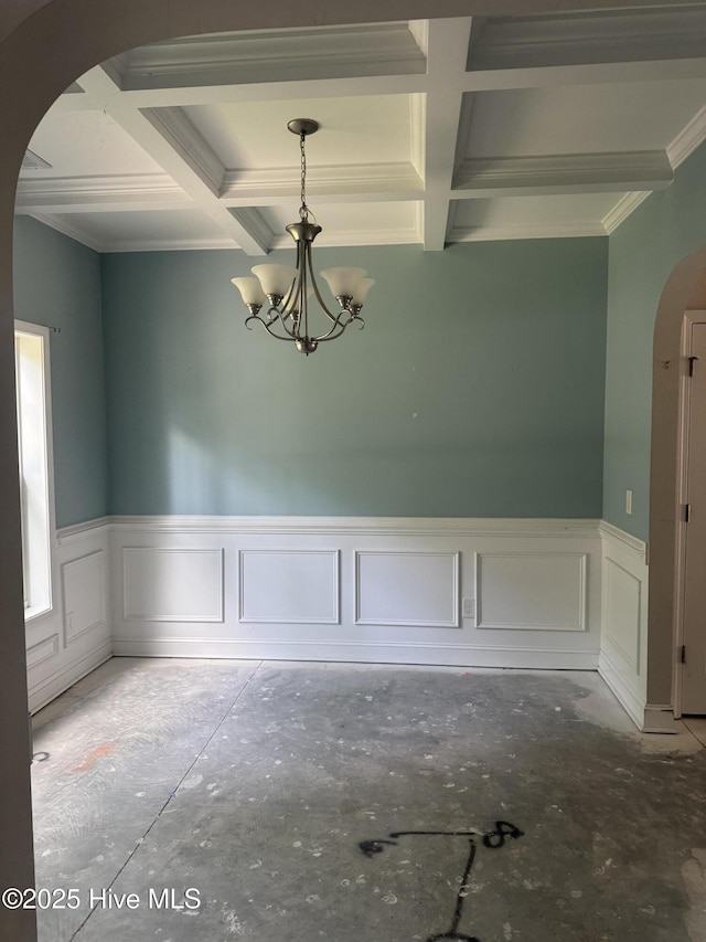 600 Burning Tree Rd, Pinehurst, NC 28374 - unfurnished dining area featuring arched walkways, coffered ceiling, a chandelier, a wainscoted wall, and beamed ceiling
