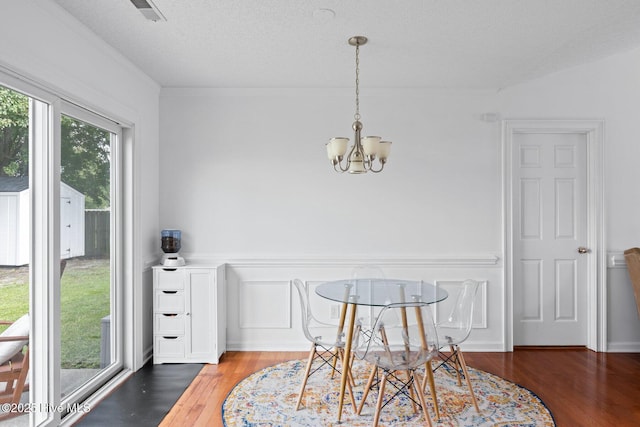 2827 Sapling Cir, Wilmington, NC 28411 - dining space with a chandelier, wood finished floors, and ornamental molding