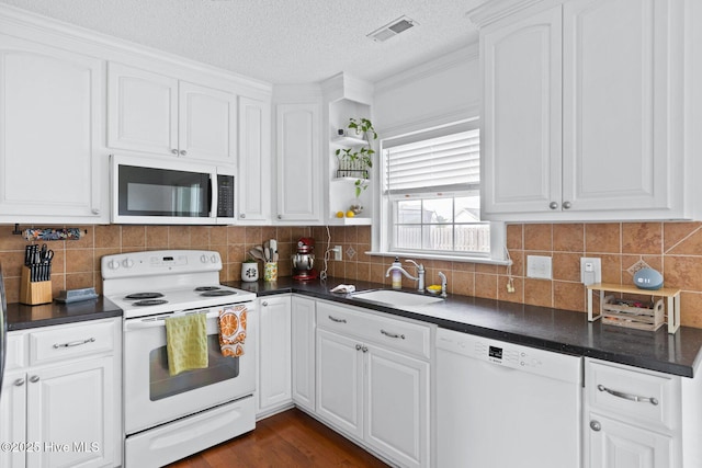2827 Sapling Cir, Wilmington, NC 28411 - kitchen featuring white appliances, dark countertops, white cabinets, decorative backsplash, and a textured ceiling