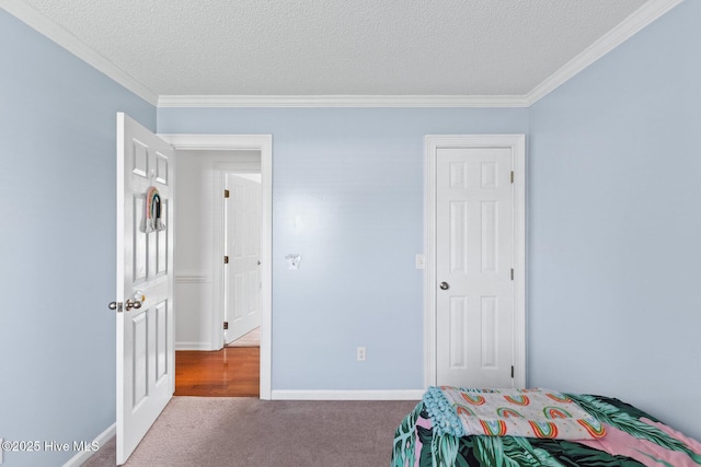 2827 Sapling Cir, Wilmington, NC 28411 - bedroom featuring carpet floors, a textured ceiling, and ornamental molding