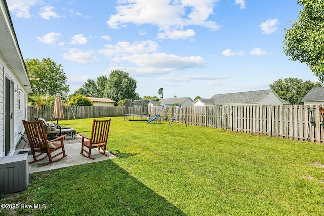2827 Sapling Cir, Wilmington, NC 28411 - fenced backyard with a trampoline, a patio, and a playground