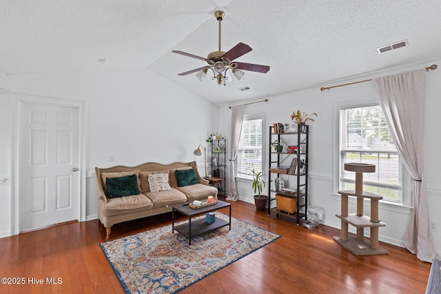 2827 Sapling Cir, Wilmington, NC 28411 - living area featuring a ceiling fan, healthy amount of natural light, wood finished floors, vaulted ceiling, and a textured ceiling