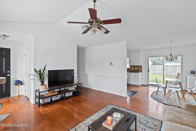 2827 Sapling Cir, Wilmington, NC 28411 - living room featuring wood finished floors, a chandelier, vaulted ceiling, and a ceiling fan